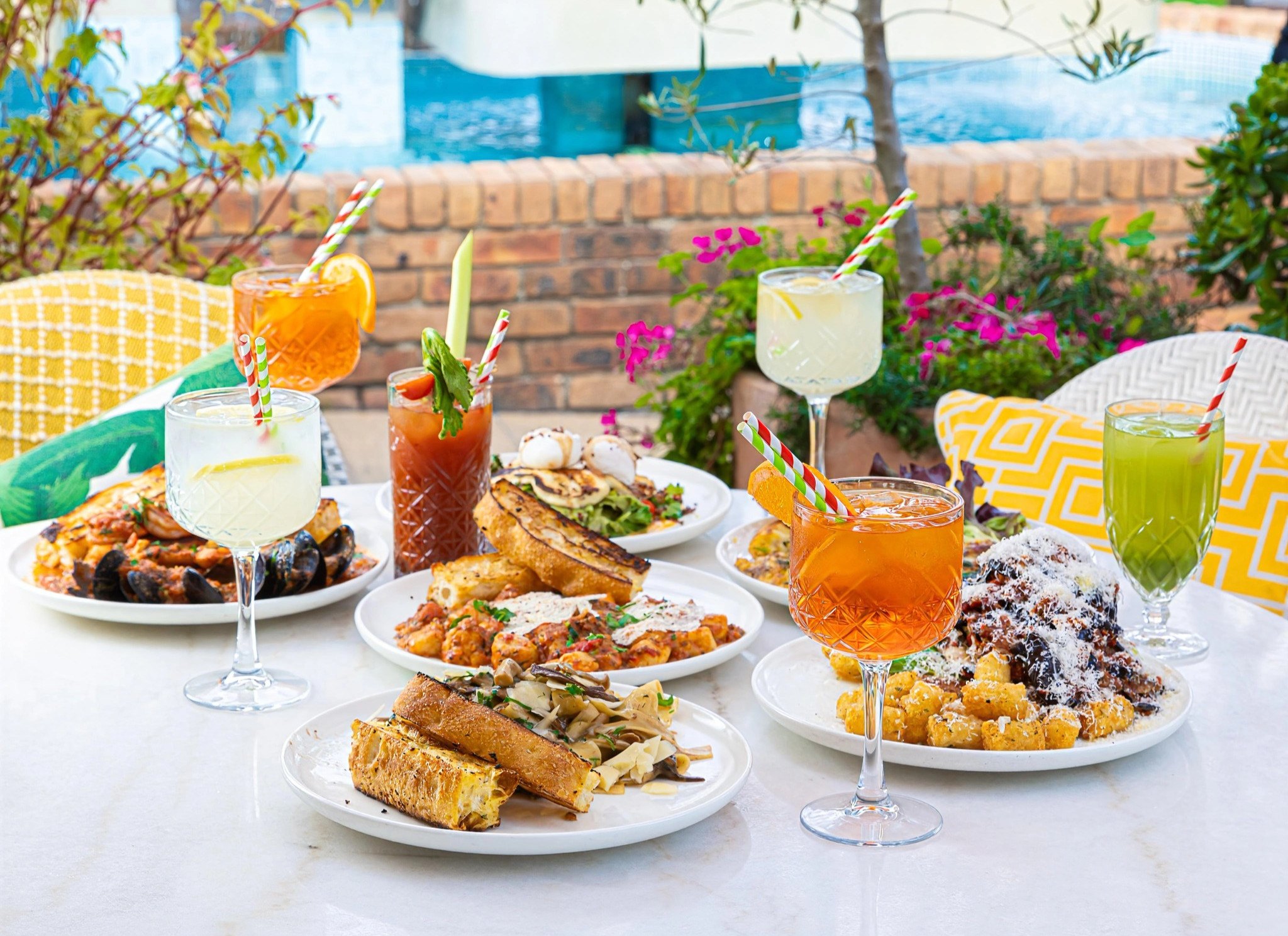 A colourful La Bottega table set with food and drinks